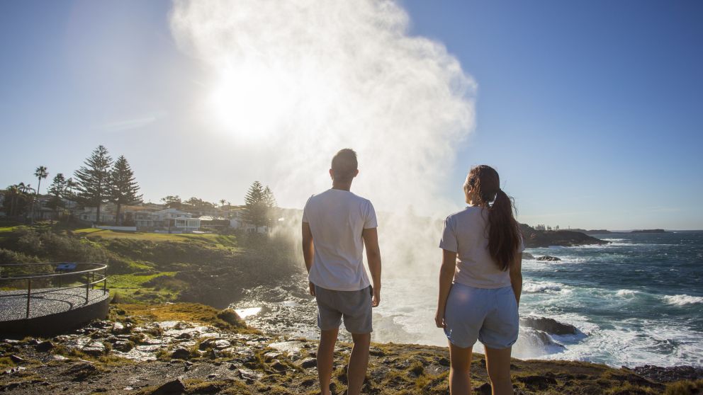 Couple watching the water plume from the Kiama blowhole
