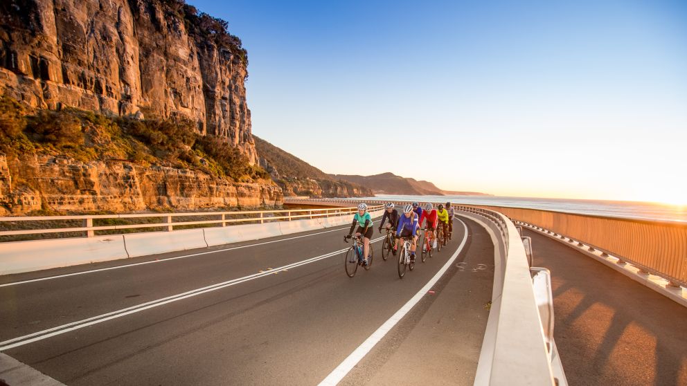 Biking in a group along Sea Cliff Bridge