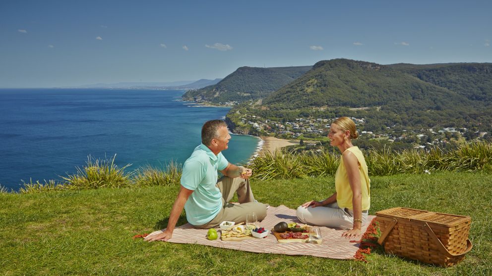 A couple enjoy the views from Stanwell Tops Lookout in Royal National Park