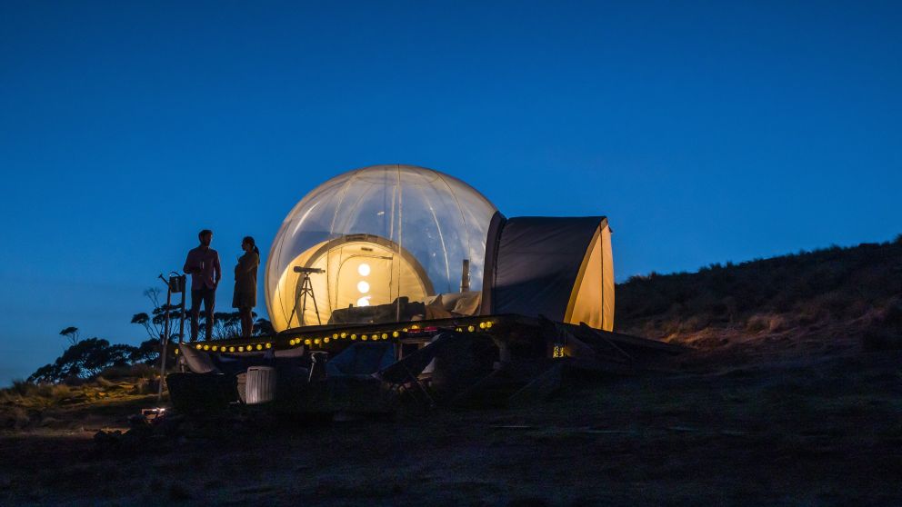 Couple relaxing in their Bubble tent Australia accommodation in the Capertee Valley