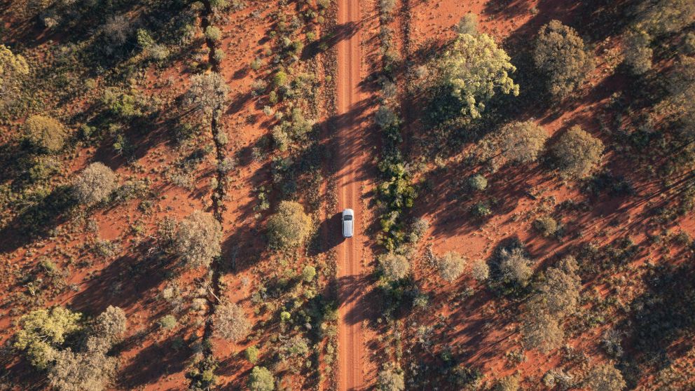 Vehicle approaching Mount Oxley near the town of Bourke in Outback NSW