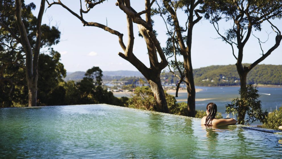 Woman relaxing in the pool at Pretty Beach House in Pretty Beach, Central Coast