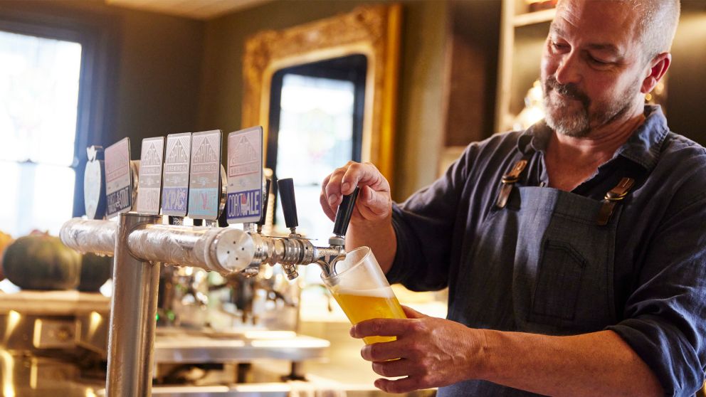 Man pouring a beer at the Argyle Inn, Taralga