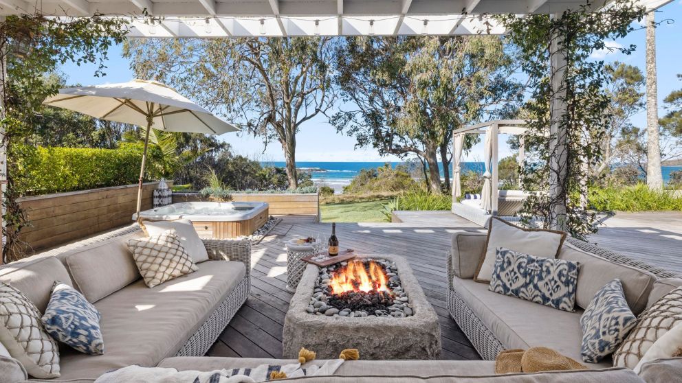 Outdoor seating with fire pit and lounge chairs at Barellen Beach House, Coffs Harbour