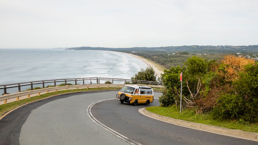 Students in campervan driving towards Cape Byron Lighthouse, Byron Bay