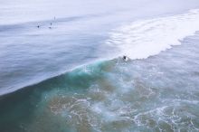Surfers catching waves at Seven Mile Beach which stretches from Gerroa to Shoalhaven Heads, Kiama Area, South Coast