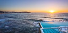 Morning sun rising over Bondi Icebergs, Bondi Beach