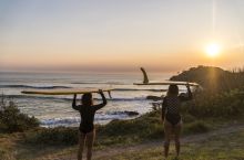 Surfers watching the sunrise at Cabarita Beach - North Coast
