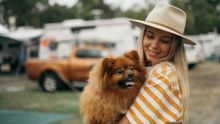 Woman holding dog at Reflections Holiday Parks, Lennox Head 