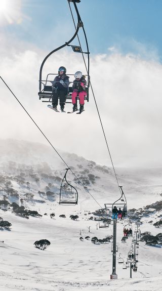 Skiers riding the chair lifts at Charlotte Pass Ski Resort in the Snowy Mountains