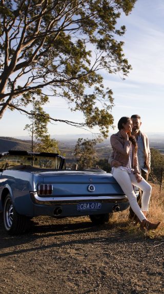 Couple enjoying views across Hunter Valley from Mount View Road, Pokolbin in the Hunter Valley