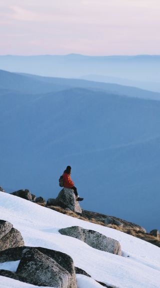 Woman enjoying the scenic views across Kosciuszko National Park in the Snowy Mountains