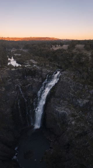 Sun rising over Apsley Falls in Oxley Wild Rivers National Park