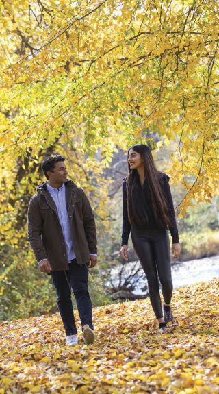 Couple enjoying the autumn colours along the Tumut River Walk