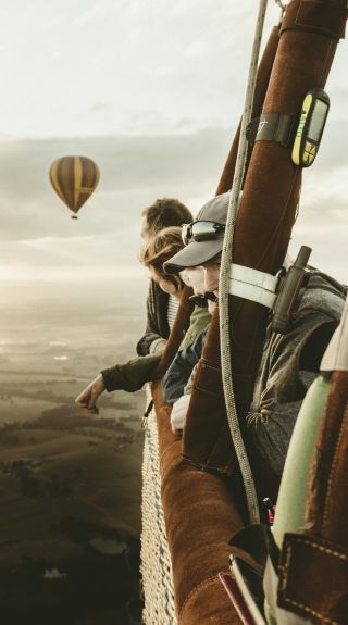 People enjoying a hot air balloon ride over the Hunter Valley