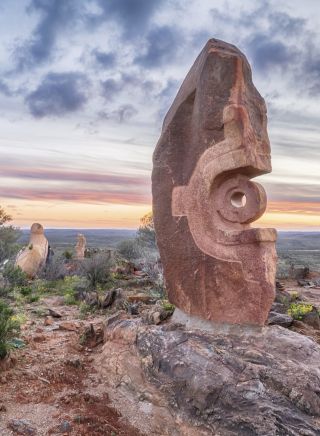 The sun sets over a large stone sculpture at the Living Desert Reserve, Broken Hill