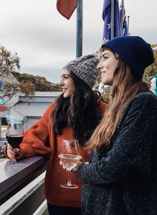 Women enjoying a glass of wine at The Local Pub in Thredbo Village, Snowy Mountains