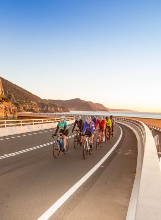 Group biking along Sea Cliff Bridge