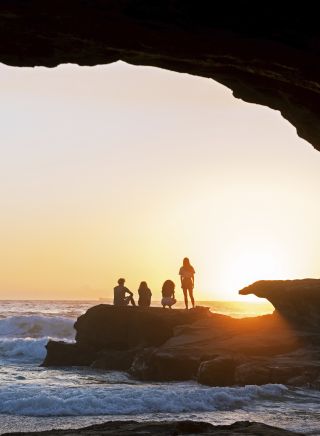 Friends enjoying a warm sunrise from Caves Beach, Lake Macquarie