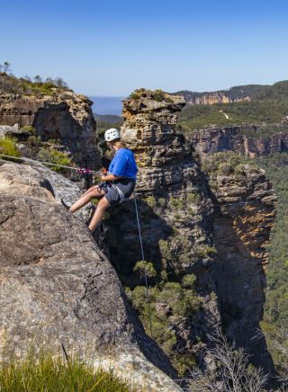 Woman abseiling at Cahills Lookout, Katoomba in the Blue Mountains