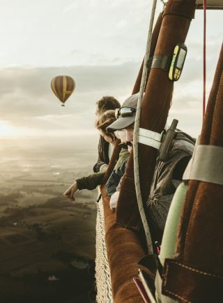 People enjoying a hot air balloon ride over the Hunter Valley