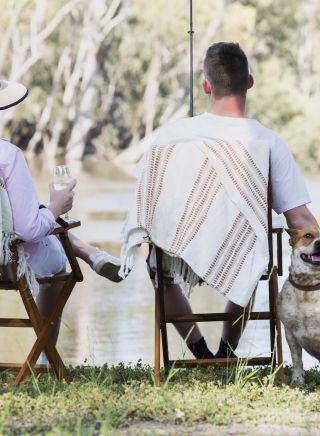 Couple and their dog enjoying an afternoon of fishing on the banks of the Murrumbidgee River, Hay