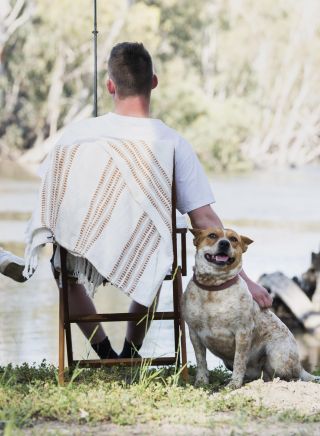 Couple and their dog enjoying an afternoon of fishing on the banks of the Murrumbidgee River, Hay