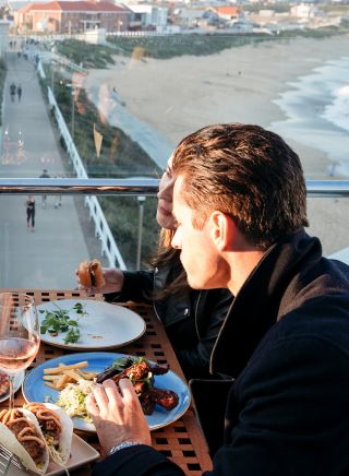 Friends enjoying food and drink with ocean views, Merewether Surfhouse, Newcastle