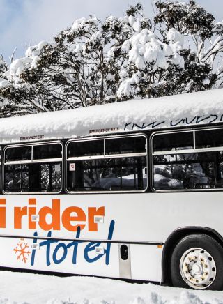 Hotel bus covered in fresh snow at Ski Rider Hotel, Kalkite