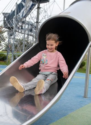 Child enjoying slide at The Big Golden Guitar Tourist Centre, Tamworth