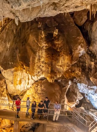 Small group enjoying a tour through a cave system at Jenolan Caves, Blue Mountains
