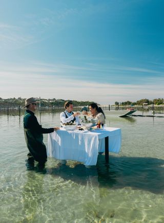 Couple on an oyster tasting experience on the waters with Merimbula Oyster Tours, Merimbula 
