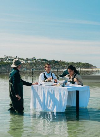 Couple on an oyster tasting experience on the waters of Merimbula Lake, Merimbula Oyster Tours, Merimbula