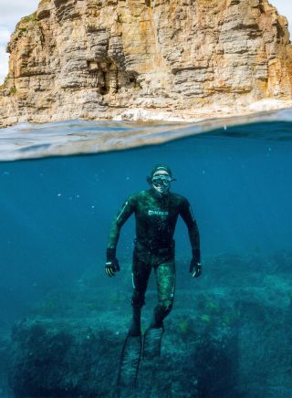 Freediver under water with rock, Jervis Bay Sea Sports, Jervis Bay - Credit: Jordan Robins