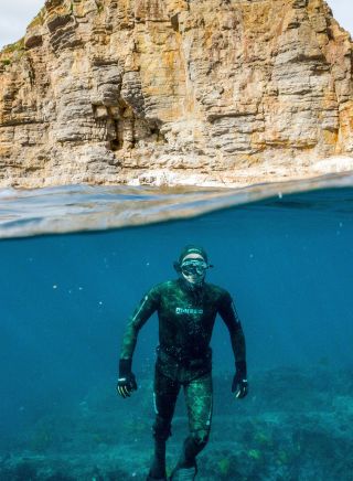 Freediver under water with rock, Jervis Bay Sea Sports, Jervis Bay - Credit: Jordan Robins