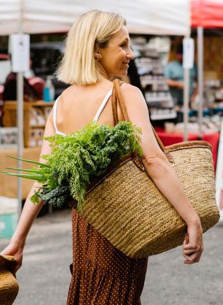 Woman enjoying a visit with market basket, Yamba Farmers and Producers Market, Yamba 