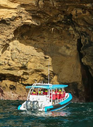 Boat outside a sea cave, CoastXP boat tour, Lake Macquarie