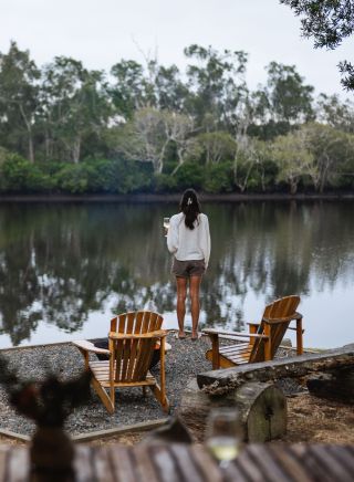 Couple enjoying roasting marshmellows by the camp fire at Myall River Camp, Hawks Nest