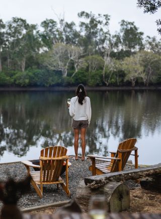 Couple enjoying roasting marshmellows by the camp fire at Myall River Camp, Hawks Nest