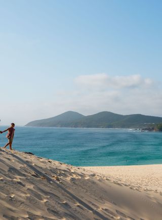 Couple enjoying the stunning views from One Mile Sand Dune, Forster