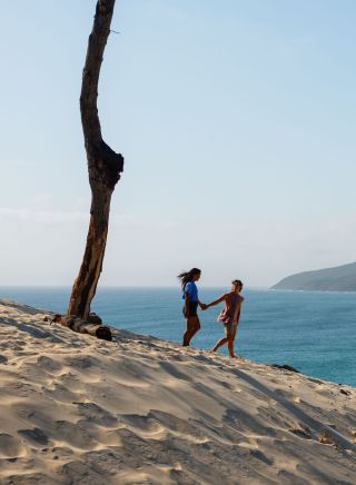 Couple enjoying the stunning views from One Mile Sand Dune, Forster
