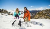 Friends building a snowman at Thredbo in the NSW Snowy Mountains