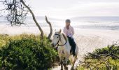 Woman enjoying a horse-riding experience with Zephyr Horses in Byron Bay