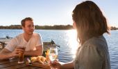 Couple enjoying fish and chips by the water at Tuross Boatshed & Cafe, Tuross Head