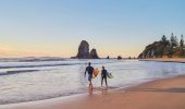 Father and son heading out for a morning surf at Glasshouse Rocks, Narooma