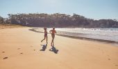 Couple enjoying a visit to McKenzies Beach at Malua Bay in Batemans Bay, South Coast