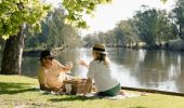 Couple enjoying a picnic along the banks of the Murray River Howlong in Howlong, The Murray