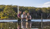 Couple enjoying a tour with Captain Sponge's Magical Oyster Tours on Pambula River, Pambula