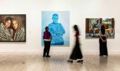 Visitors walking past artworks at Archibald, Wynne and Sulman Prizes 2025 Exhibition, Sydney