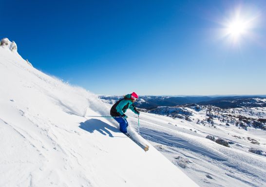 A woman skiing on a steep mountain slope in the Perisher Valley, Snowy Mountains - Credit: Perisher